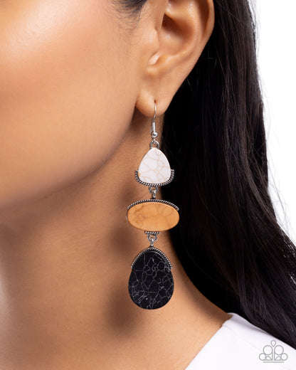 Earring with three stones worn by a person