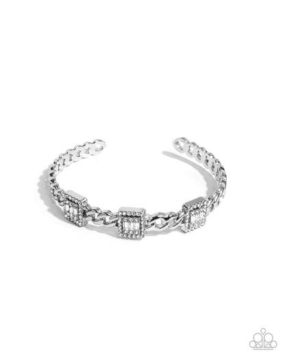 Silver bracelet with geometric design on a white background