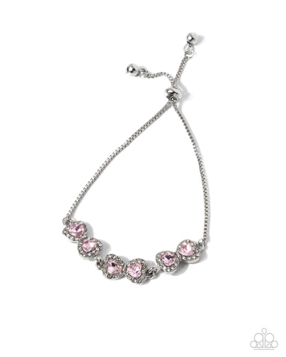 Silver bracelet with pink gemstones on a white background