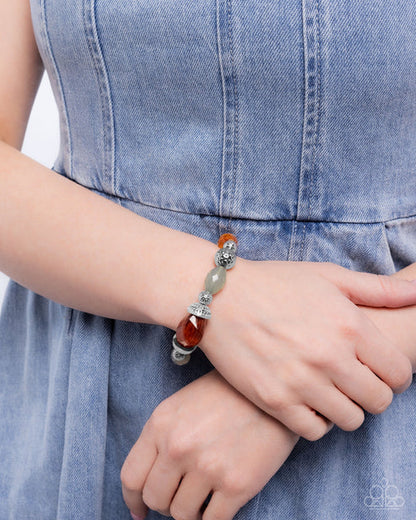 Bracelet with beads on a wrist against a denim background