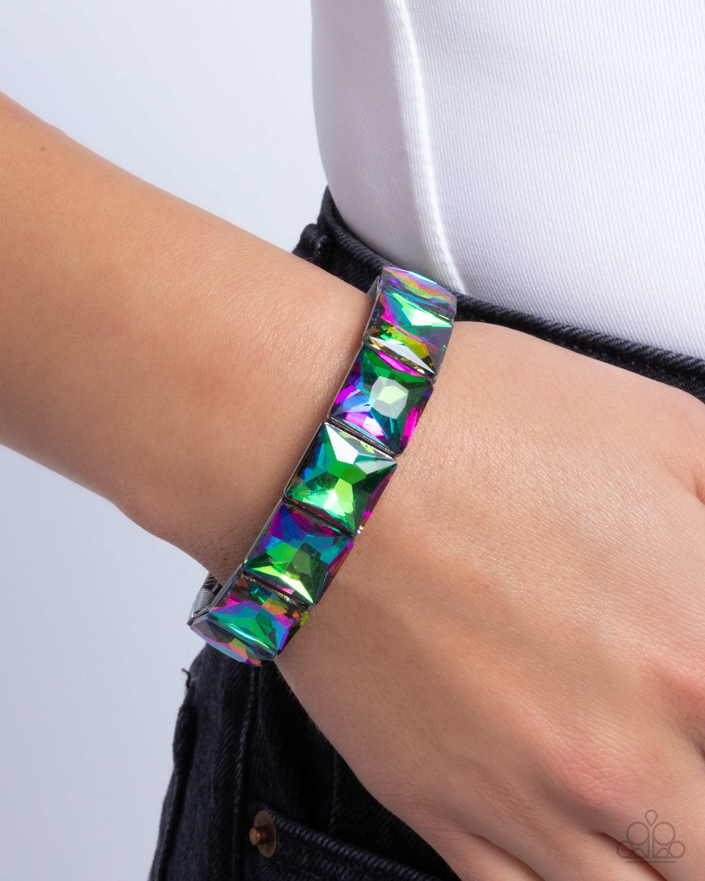Multicolored geometric bracelet on a wrist against a white background