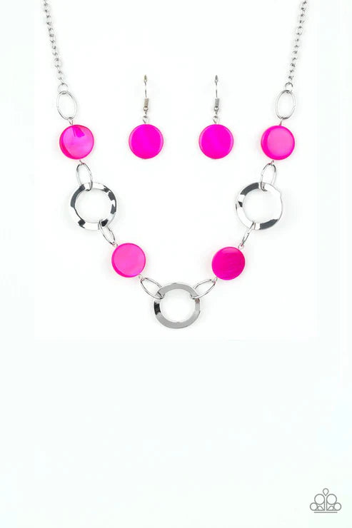 Neon pink bead necklace and earrings on a white background