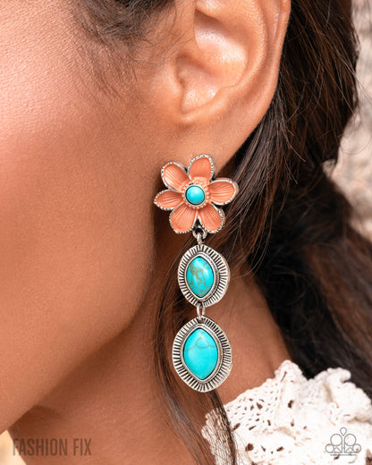 Floral earring with turquoise stones worn by a person