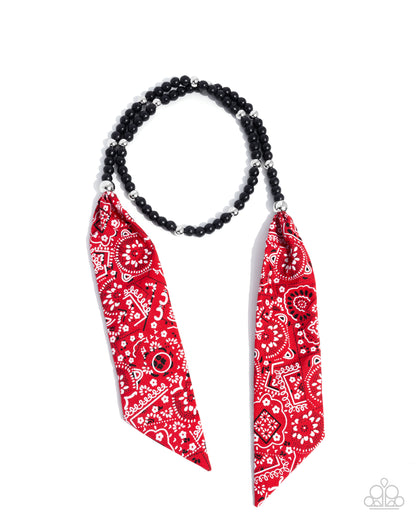Necklace with red bandana scarf and black beads on a white background