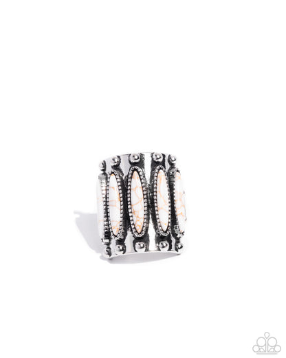 Silver ring with intricate design on a white background