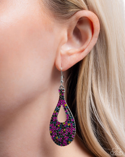 Multicolored beaded earring worn by a model with blonde hair.