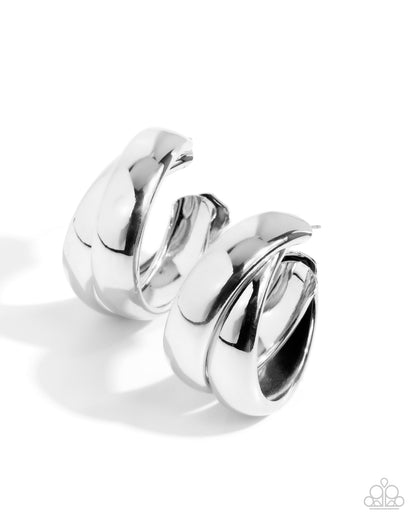 Pair of silver hoop earrings on a white background