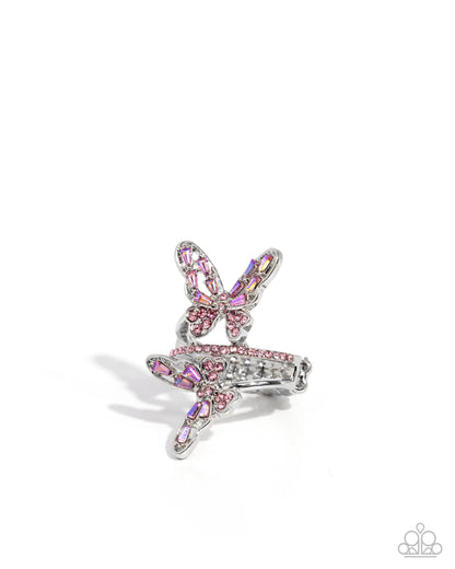 Butterfly-shaped earring with pink and clear gemstones on a white background