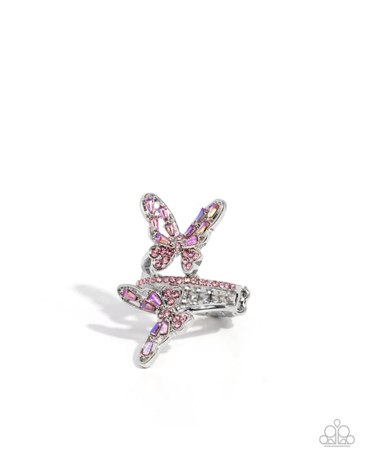 Butterfly-shaped earring with pink and clear gemstones on a white background