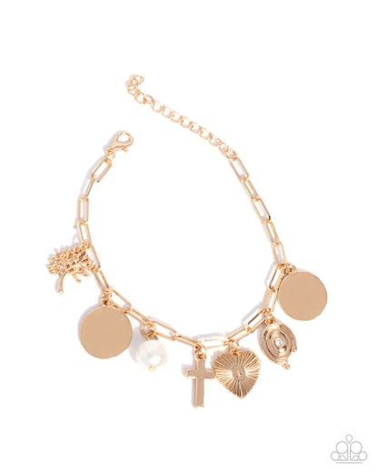 Gold bracelet with various charms on a white background