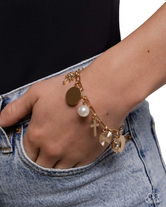 Bracelet with various charms on a wrist against a white background