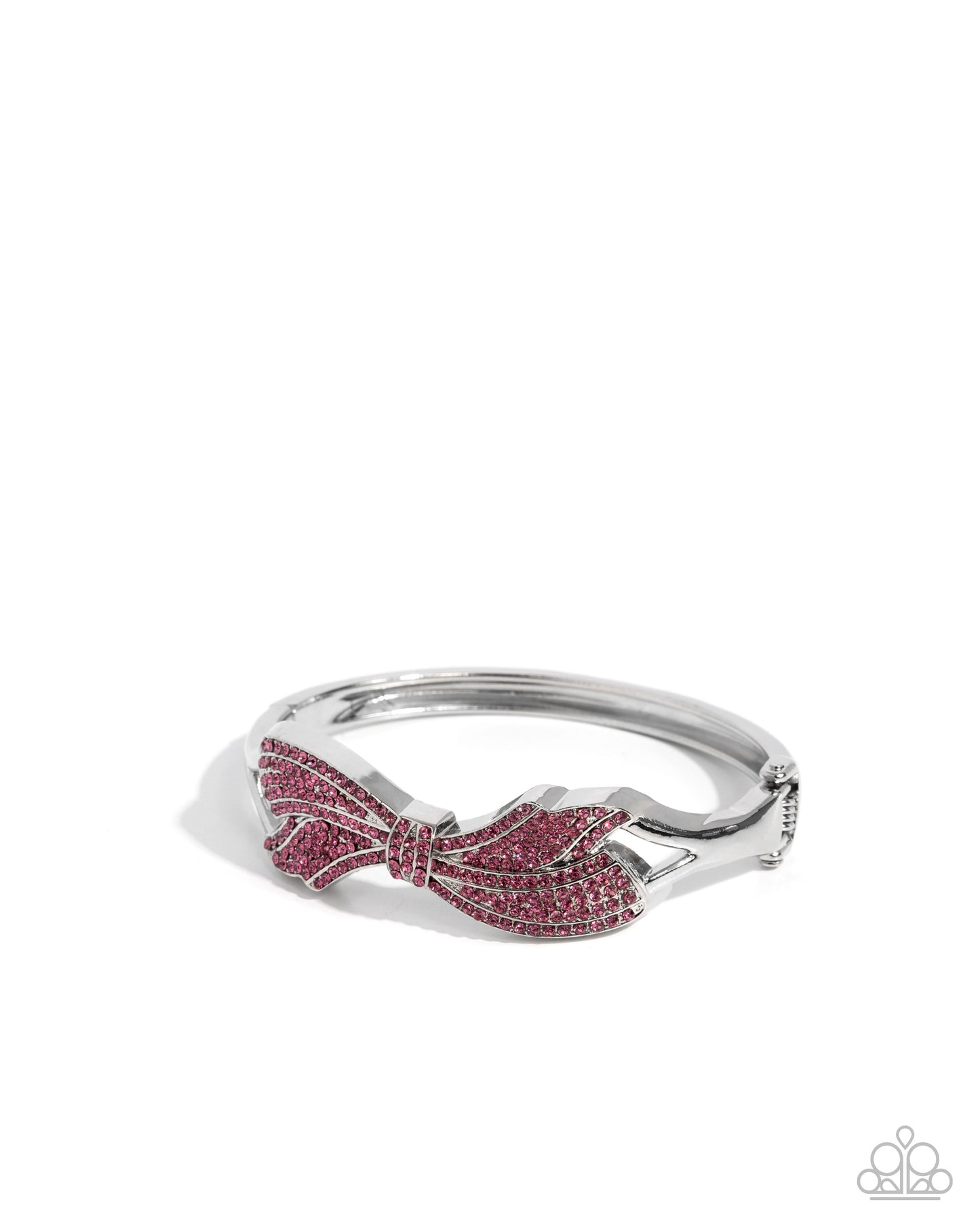 Silver ring with pink gemstone bow design on a white background
