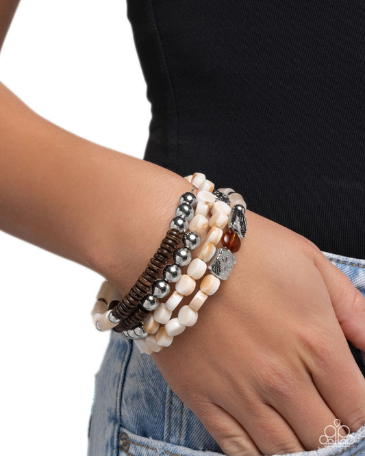 Stack of beaded bracelets on a wrist with a blurred background