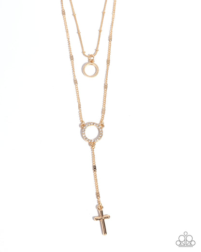 Rose gold necklace with circular pendants and a cross on a white background