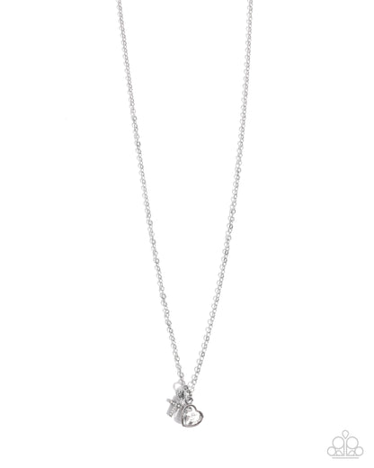 Silver necklace with a small pendant on a white background