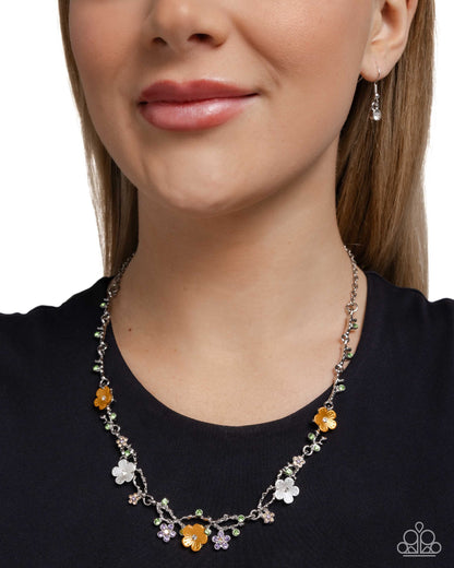 Woman wearing a floral necklace with a plain background