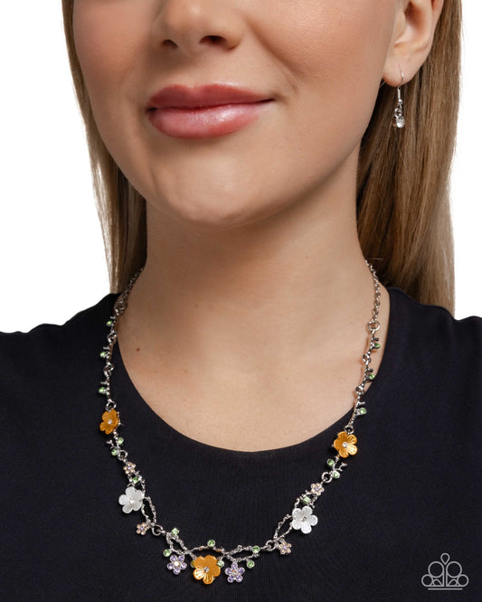 Woman wearing a floral necklace with a plain background