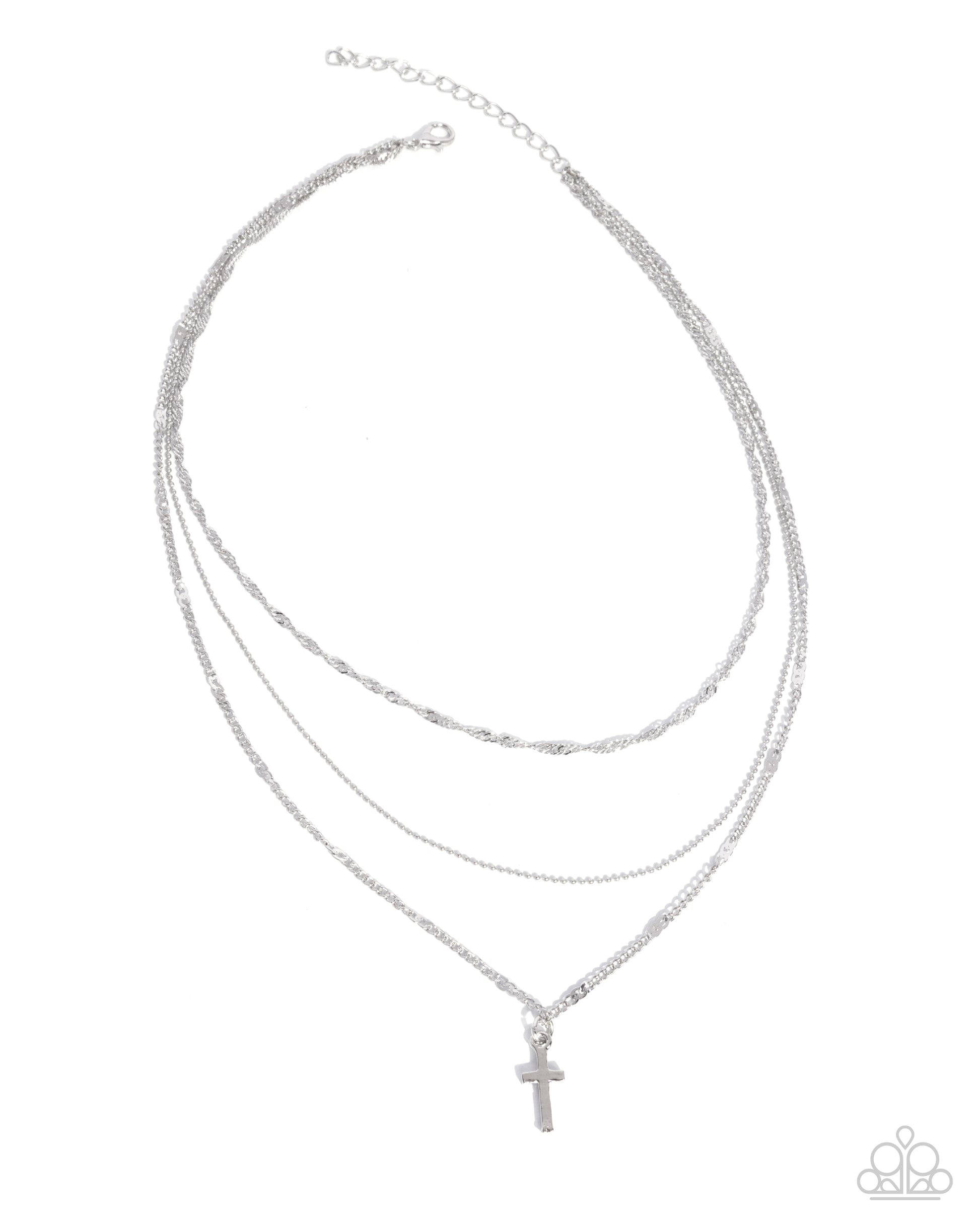 Stack of silver necklaces with a cross pendant on a white background