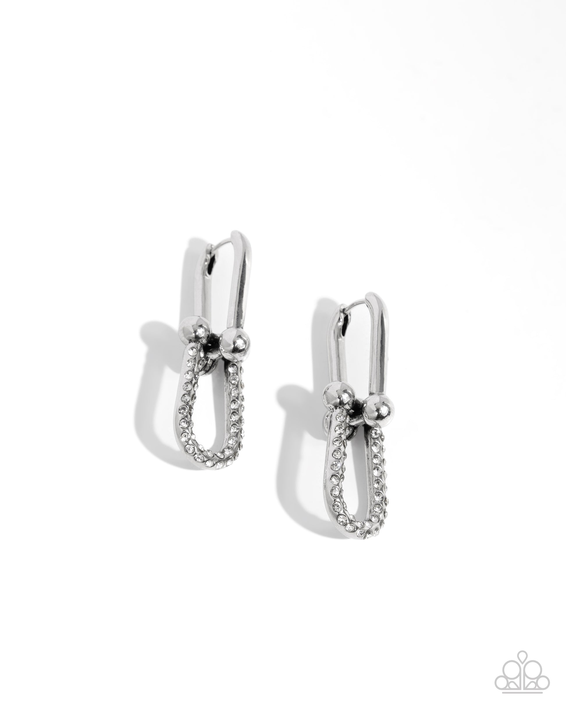 A pair of silver-toned hoop earrings with a textured pavé band and small bead details, shown on a clean white background with soft shadows.