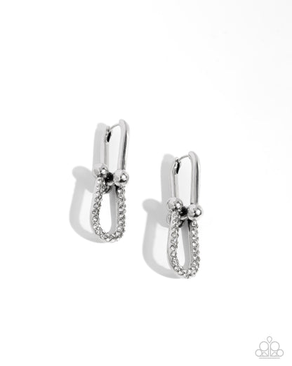 A pair of silver-toned hoop earrings with a textured pavé band and small bead details, shown on a clean white background with soft shadows.