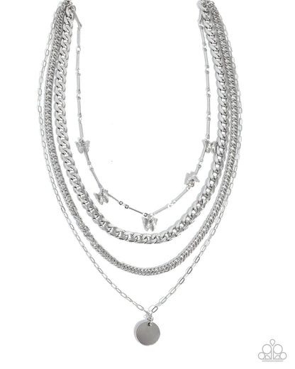 Stack of silver necklaces on a white background