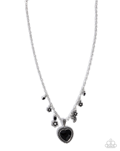 Necklace with black heart pendant and floral elements on a white background