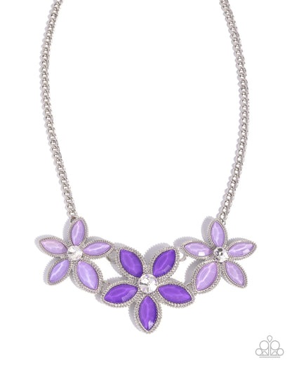 Necklace with purple floral pendants on a white background