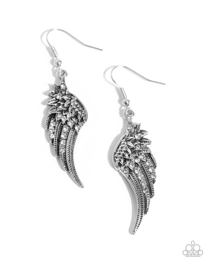 A pair of silver-toned wing-shaped dangle earrings with clear rhinestone embellishments, shown on a plain white background.