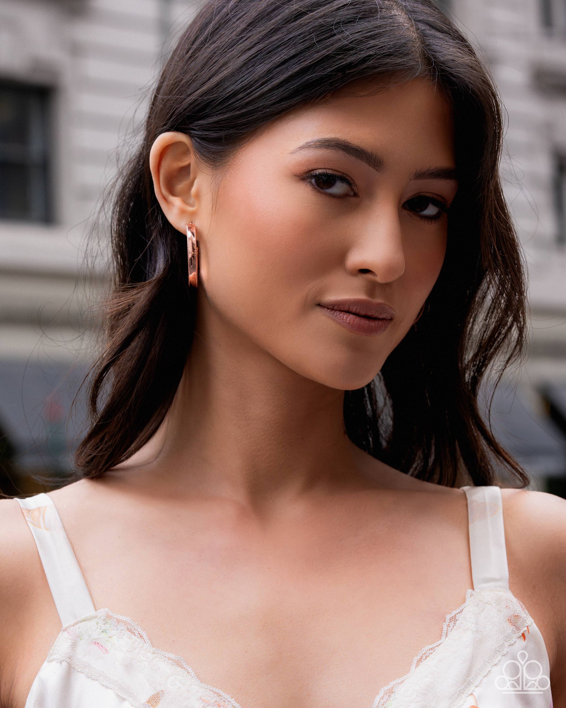 Woman wearing a white lace top with a blurred background