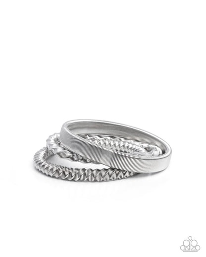 Set of three silver rings on a white background