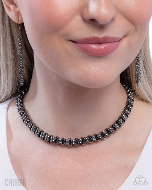 Necklace worn by a model on a plain background