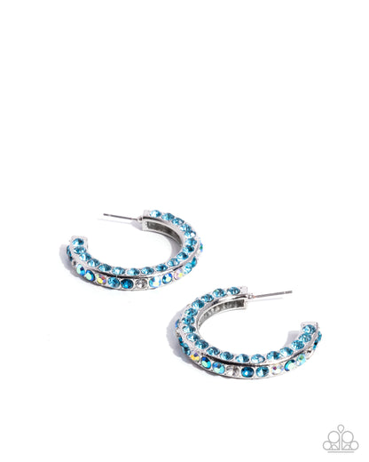 Pair of blue hoop earrings on a white background