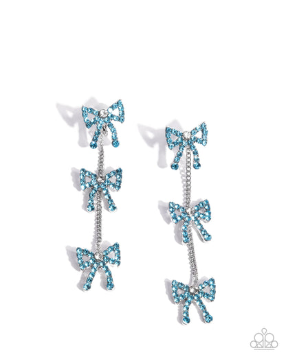 Pair of earrings with blue bow designs on a white background