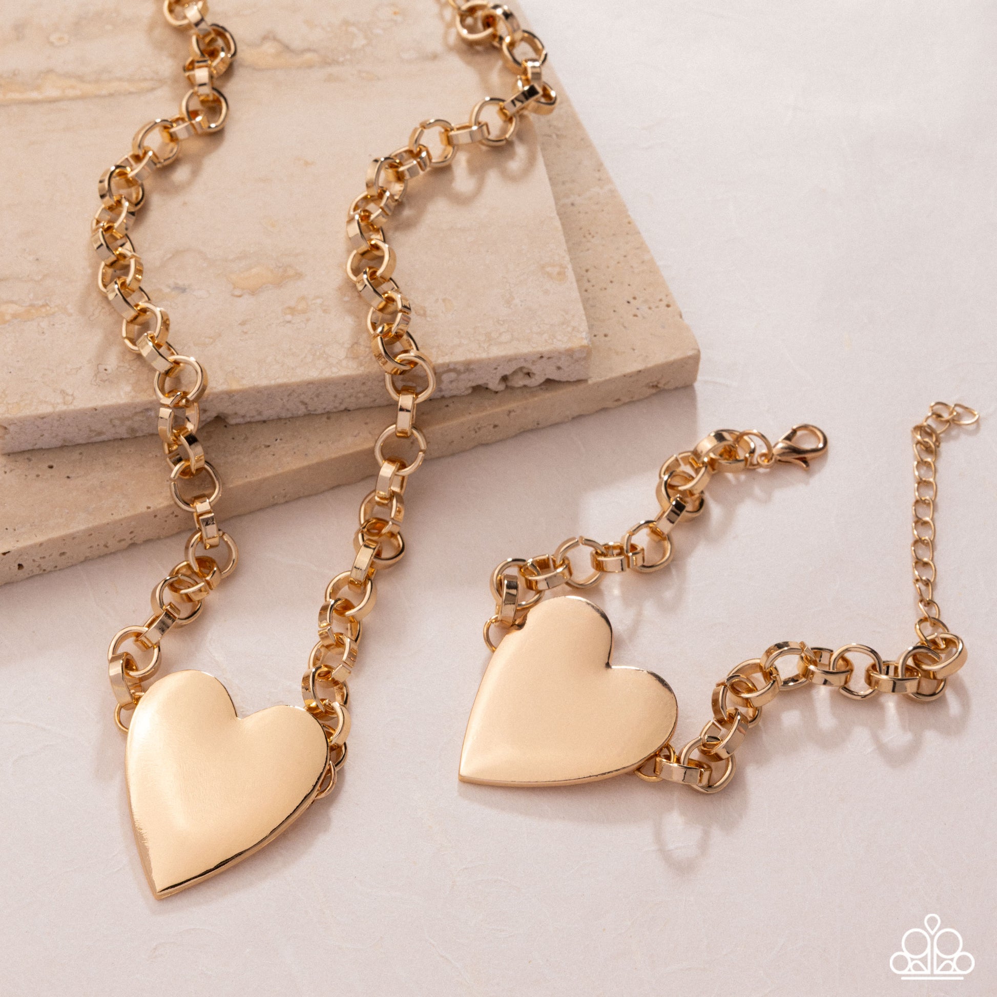 Gold heart-shaped bracelet on a light background