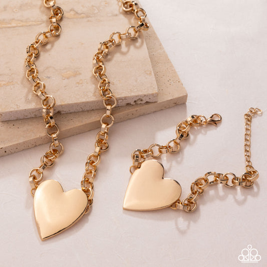 Gold heart-shaped bracelet on a light background
