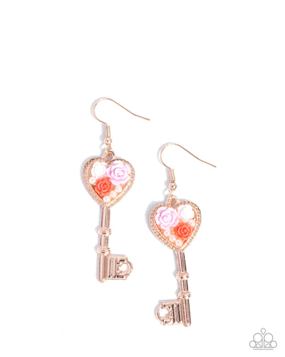 Rose gold key-shaped earrings with floral designs on a white background