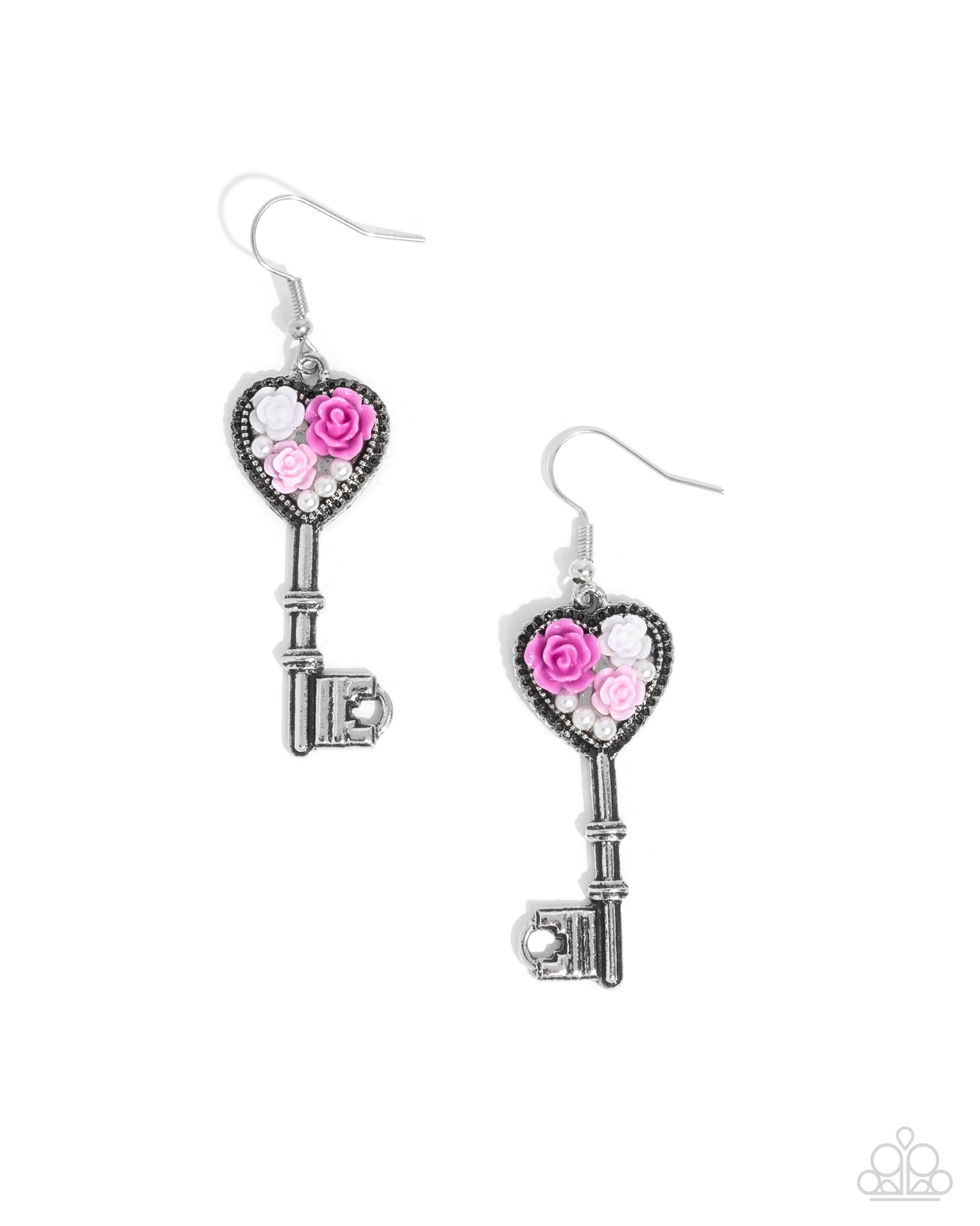 Pair of silver key-shaped earrings with pink and white floral accents on a white background