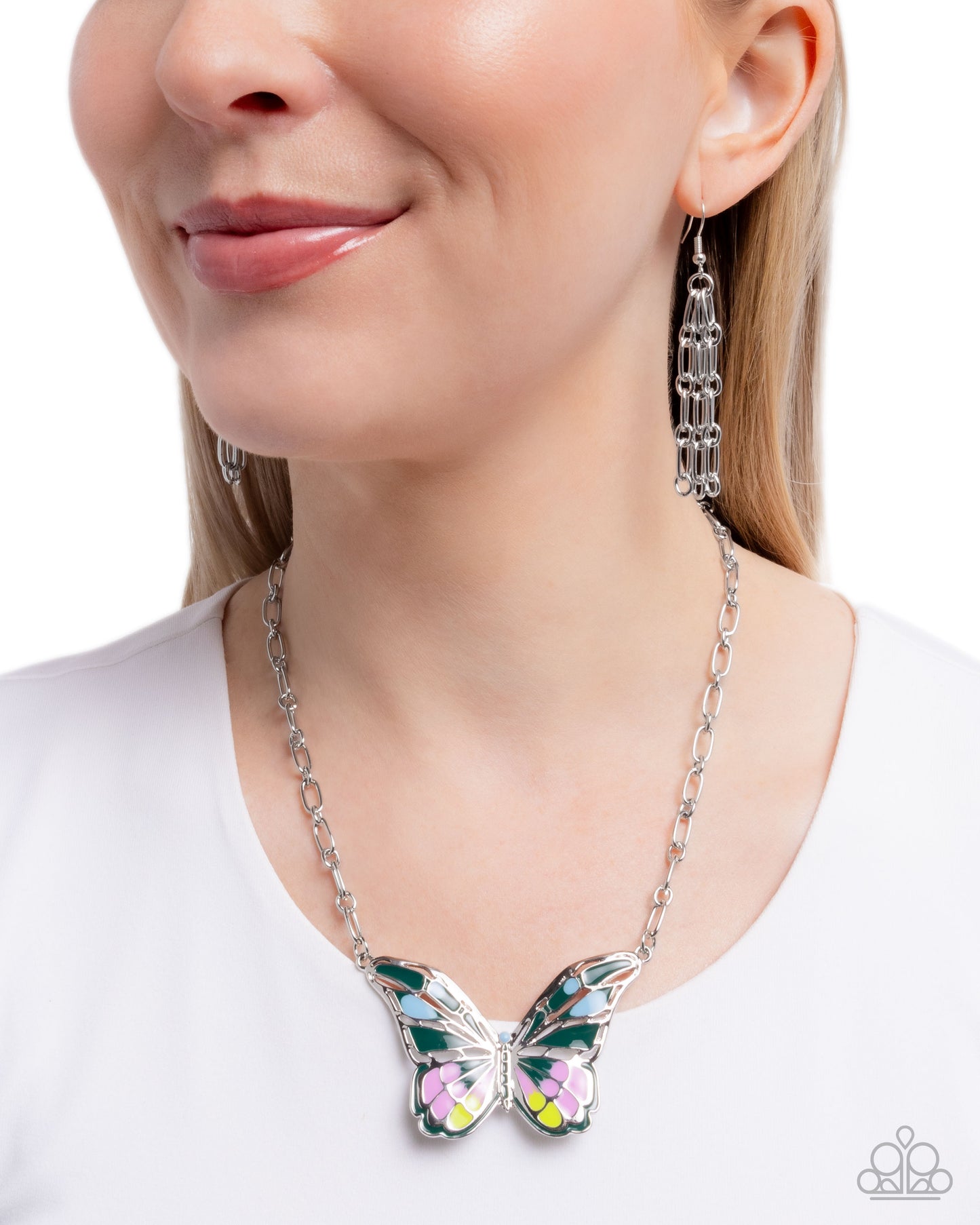 Butterfly necklace and earrings on a model against a white background