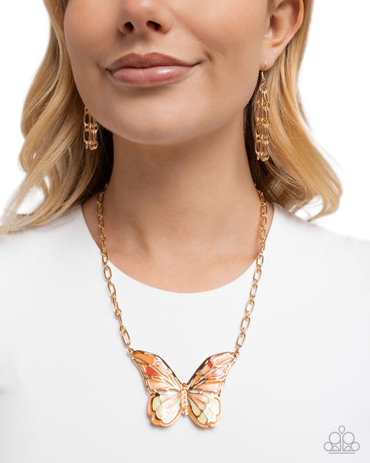 Butterfly necklace worn by a model on a white background