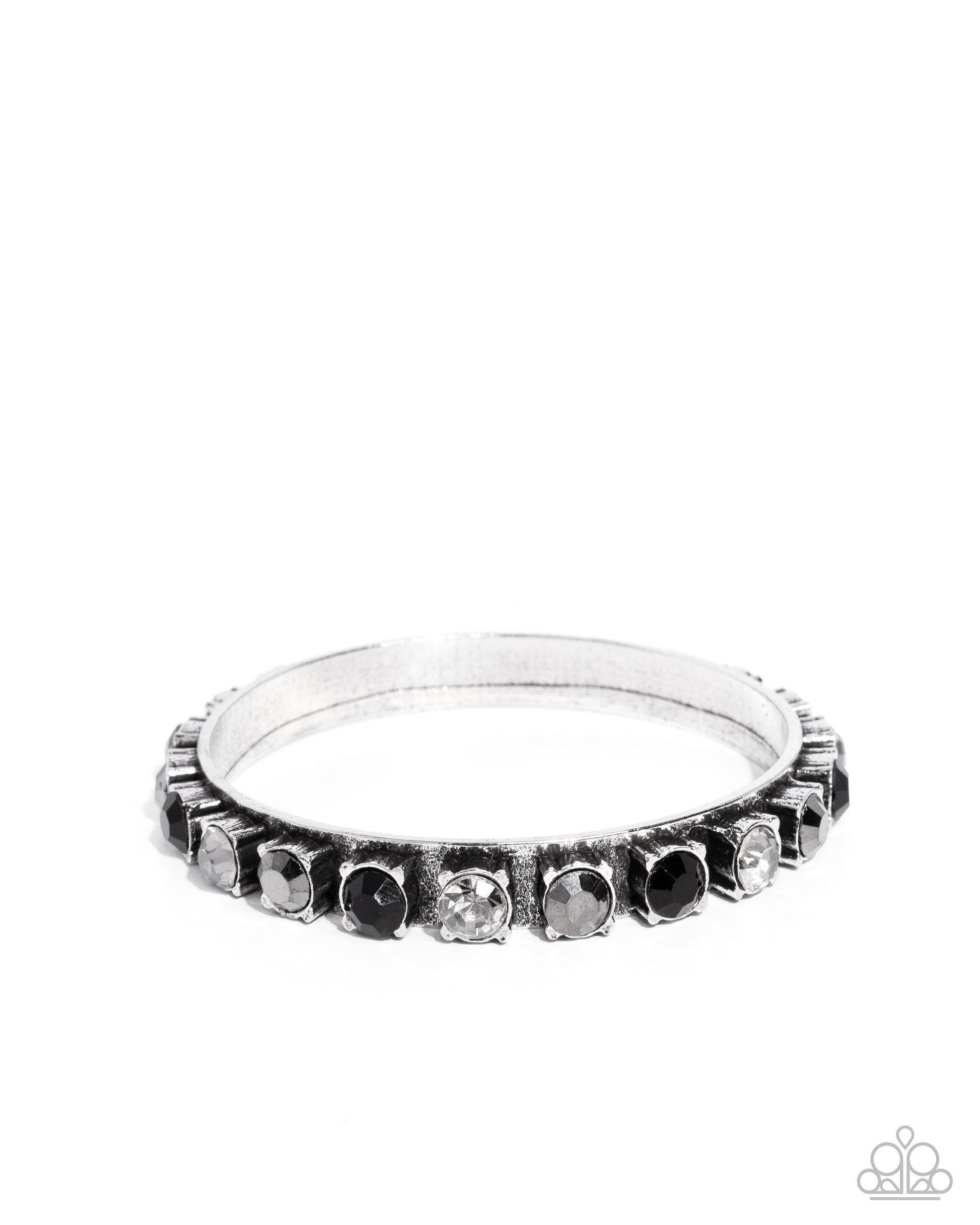 Silver ring with embedded stones on a white background
