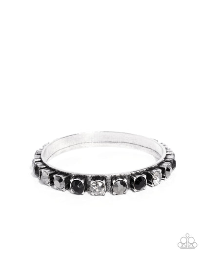Silver ring with embedded stones on a white background