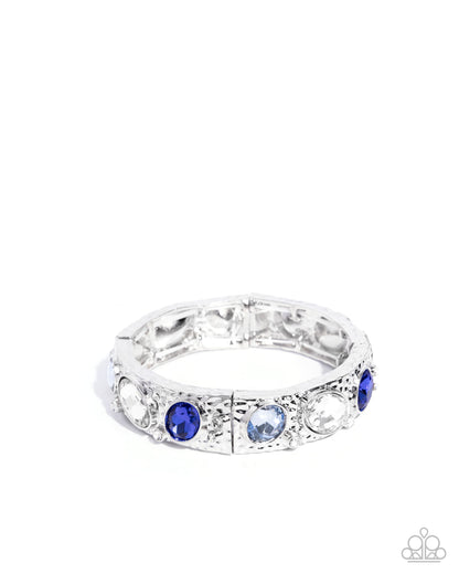 Silver ring with blue gemstones on a white background