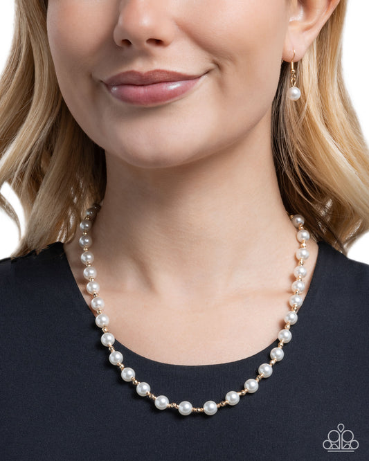 Pearl necklace worn by a model against a neutral background
