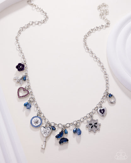 Silver necklace with various charms on a white background