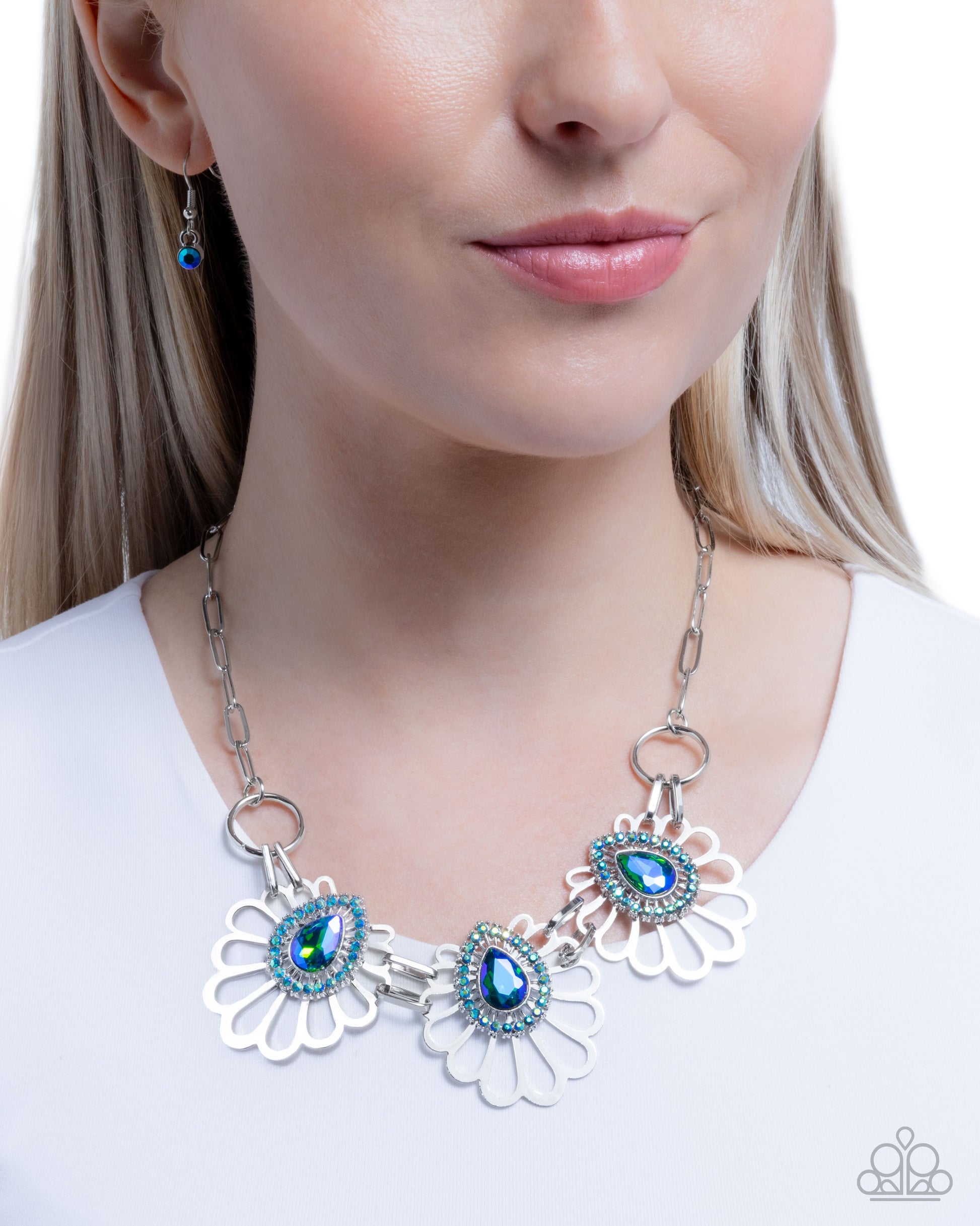 Necklace with blue gemstones worn by a model on a white background