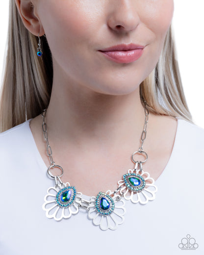 Necklace with blue gemstones worn by a model on a white background
