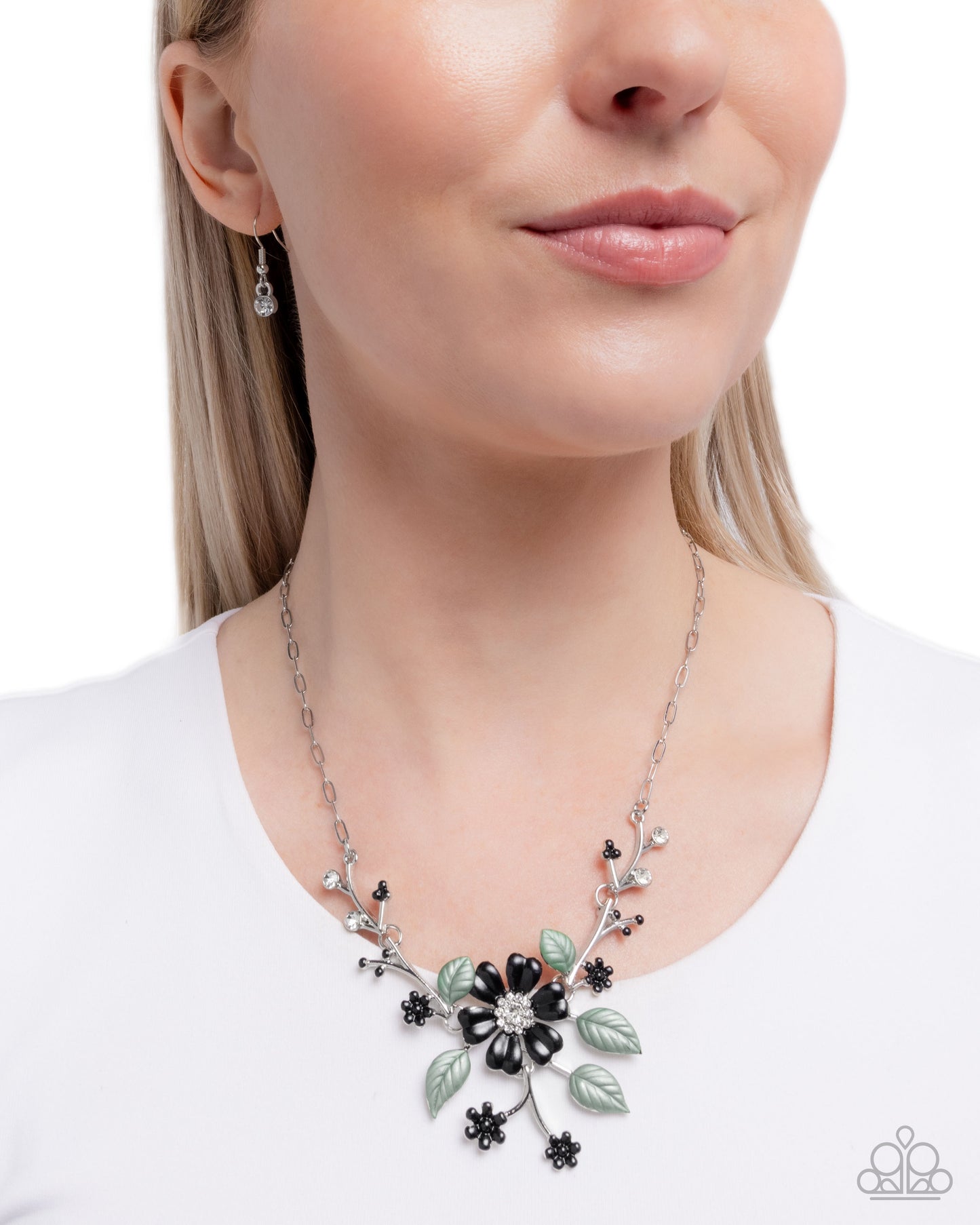 Necklace with floral design worn by a model on a white background