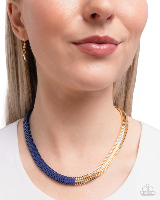 Woman wearing a blue and gold necklace on a white background