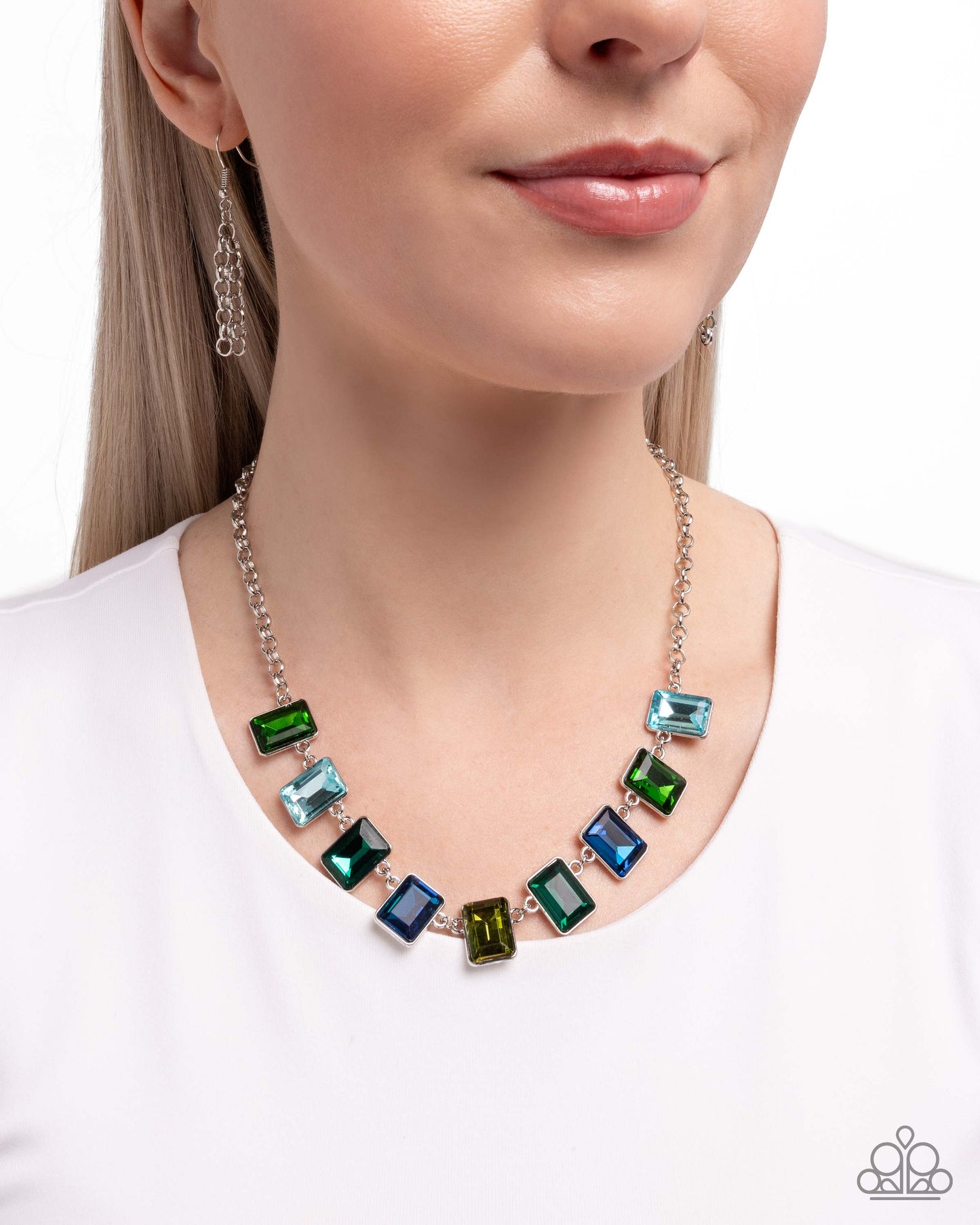 Necklace with multicolored gemstones worn by a model on a white background