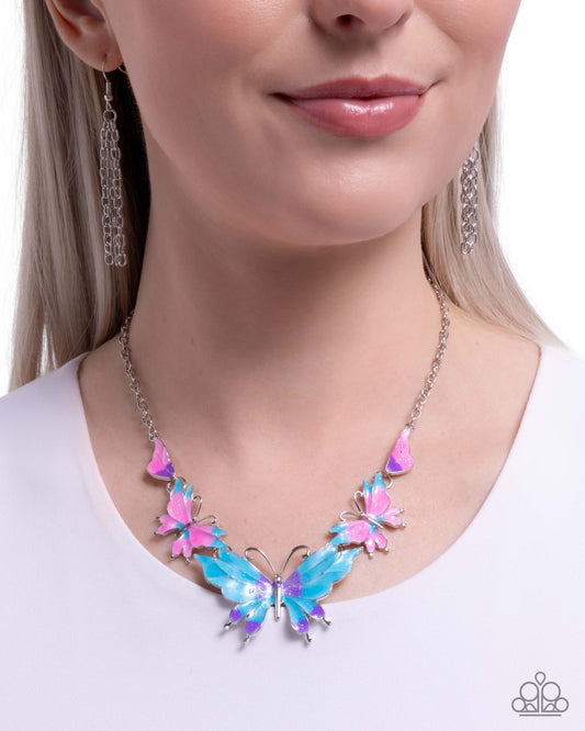 Woman wearing a colorful butterfly necklace with a white background